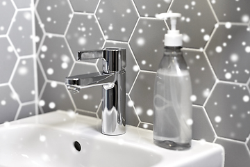 Image showing close up of water tap with liquid soap on sink