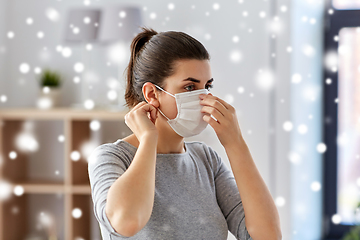 Image showing young woman wearing protective medical mask