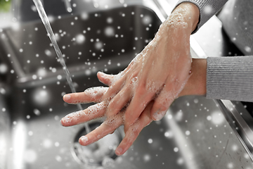 Image showing woman washing hands with soap in kitchen