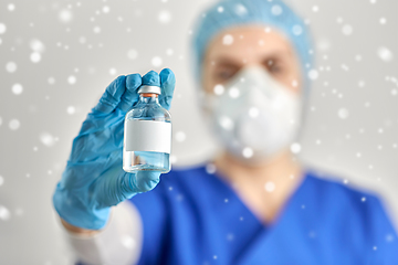 Image showing close up of doctor's hand with bottle of medicine