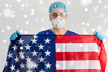 Image showing doctor in goggles and mask holding flag of america