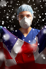 Image showing doctor in goggles and mask holding flag of america