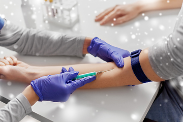 Image showing doctor taking blood for test from patient's hand