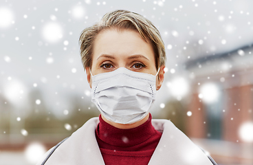 Image showing young woman wearing protective medical mask