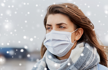 Image showing young woman wearing protective medical mask