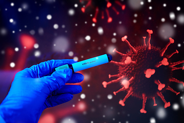 Image showing hand holding beaker with coronavirus blood test