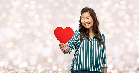 Image showing happy asian woman with red heart over lights