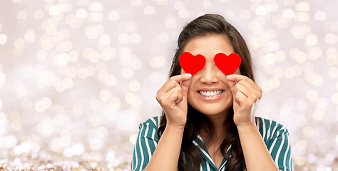 Image showing happy asian woman covering her eyes with red heart