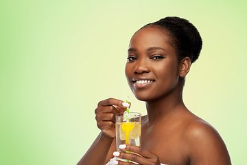 Image showing african american woman with glass of fruit water