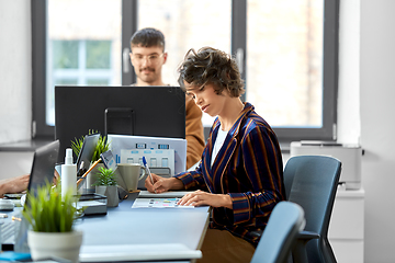 Image showing creative woman working on user interface at office