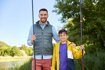 Image showing happy smiling father and son fishing on river