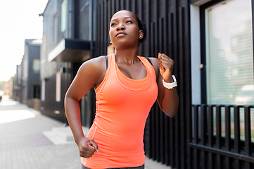 Image showing young african american woman running in city