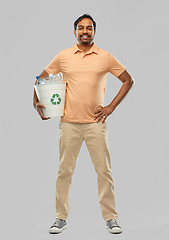 Image showing smiling young indian man sorting plastic waste