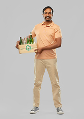 Image showing smiling young indian man sorting glass waste