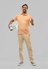 Image showing smiling young indian man sorting metallic waste