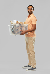 Image showing smiling young indian man sorting paper waste