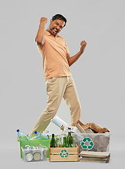 Image showing smiling man sorting paper, glass and plastic waste