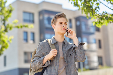 Image showing teenage student boy calling on smartphone in city