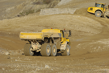 Image showing Yellow dump truck working in gravel pit