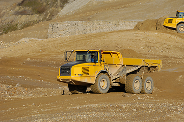 Image showing Yellow dump truck working in gravel pit