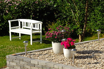 Image showing Flowers in pots in the garden