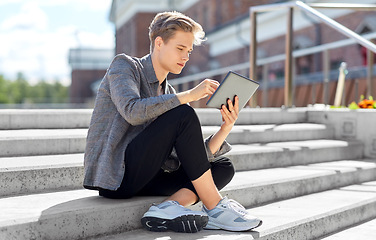 Image showing young manor teenage boy with tablet pc in city