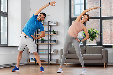 Image showing happy couple exercising at home