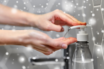 Image showing close up of woman washing hands with liquid soap