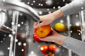 Image showing woman washing fruits and vegetables in kitchen