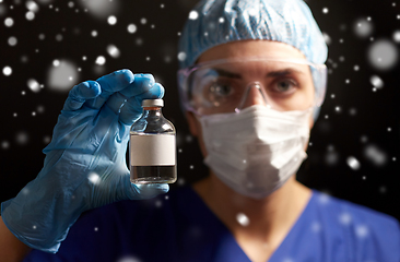 Image showing close up of doctor's hand with bottle of medicine