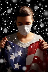 Image showing sick woman in face mask holding flag of america