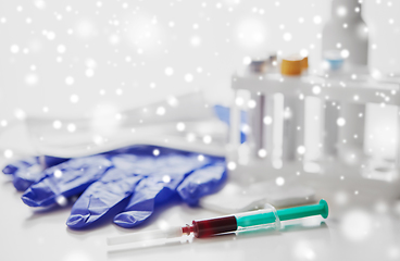 Image showing close up of blood in syringe, gloves and mask