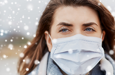 Image showing young woman wearing protective medical mask