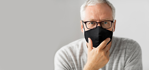 Image showing close up of senior man in glasses and black mask