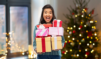 Image showing happy asian woman with christmas gifts at home