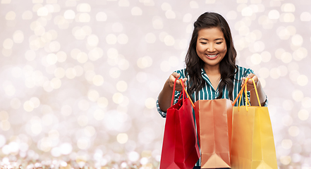 Image showing happy asian woman with shopping bags