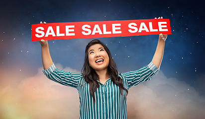 Image showing happy smiling young asian woman with sale banner