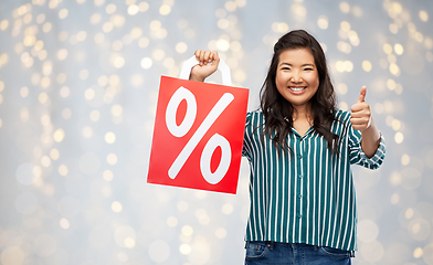 Image showing asian woman with percentage sign on shopping bags
