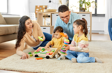 Image showing happy family palying with wooden toys at home