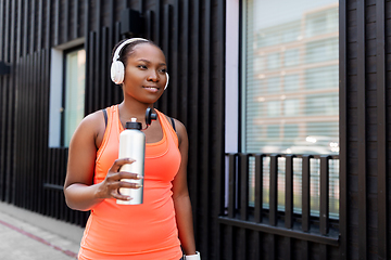 Image showing african american woman drinking water after sports