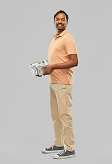 Image showing smiling young indian man sorting metallic waste