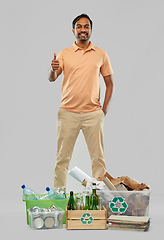 Image showing smiling man sorting paper, glass and plastic waste