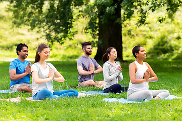 Image showing group of happy people doing yoga at summer park