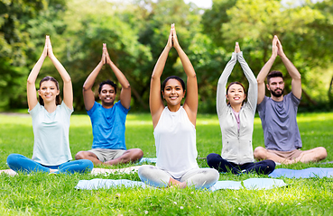 Image showing group of happy people doing yoga at summer park