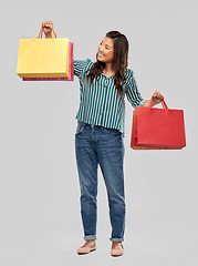 Image showing happy asian woman with shopping bags