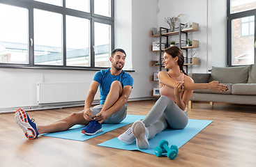 Image showing happy couple exercising at home