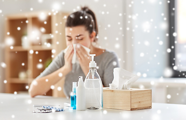 Image showing medicines and sick woman blowing nose to wipe