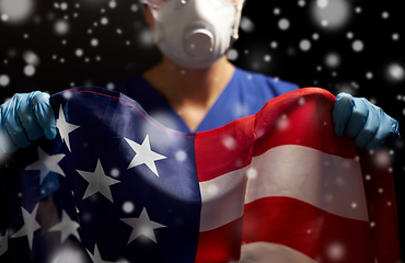 Image showing doctor in goggles and mask holding flag of america