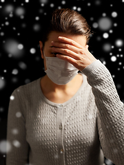 Image showing sick young woman in protective medical face mask