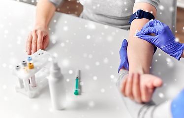 Image showing doctor and patient preparing for blood test